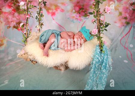 newborn baby boy relaxing, asleep on a blanket Stock Photo