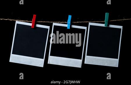 Blank square photo frames hanging on a clothesline Stock Photo