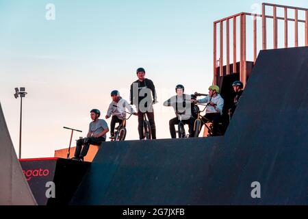 Kazan, Russia - September 12, 2020: A group of young riders on BMX bicycles on the ramp of a skate park in the city public park for active recreation Stock Photo