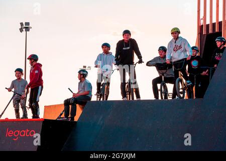 Kazan, Russia - September 12, 2020: A group of young riders on BMX bicycles on the ramp of a skate park in the city public park for active recreation Stock Photo