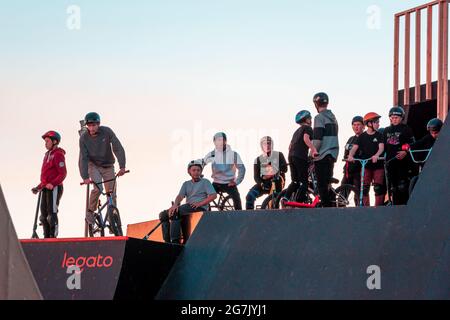 Kazan, Russia - September 12, 2020: A group of young riders on BMX bicycles on the ramp of a skate park in the city public park for active recreation Stock Photo