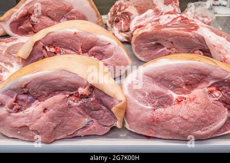 Fresh raw meat on the counter of a butcher shop in a farmer's market, butchered raw meat close-up. Stock Photo