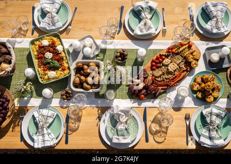 Dinner table served and decorated for big event, view from the top Stock Photo