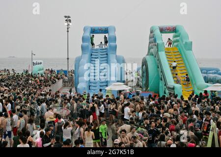 July 15, 2021-Boryeong, South Korea-A Visitors  enjoying wrestle in the mud pool during an Annual Boryeong Mud Festival at Daecheon Beach in Boryeong, South Korea. The mud, which is believed to have beneficial effects on the skin due to its mineral content, is sourced from mud flats near Boryeong and transported to the beach by truck. Stock Photo