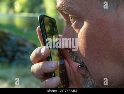 A man using dictation on his iphone. Stock Photo