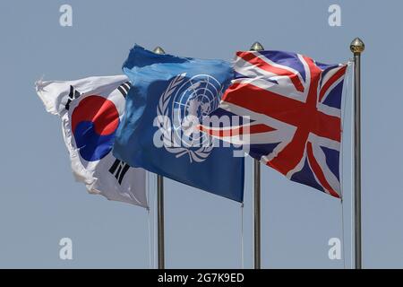 April 11, 2018-Goyang, South Korea-The England, UN, South Korea flag on a pole at Gloster Hill Memorial Park in Paju, South Kroea. The memorial stands at the foot of Gloster Hill beside the Seolmacheon stream, the initial location of the Gloucestershire Regiment's headquarters during the battle at Imjin River. It was built by units of the British and South Korean armed forces as a memorial to the Gloucestershire Regiment and C Troop, 170th Mortar Battery, Royal Artillery. Stock Photo