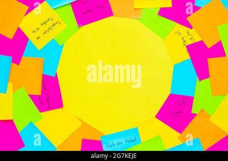 Colorful note papers to remind daily activity on yellow background. Stock Photo