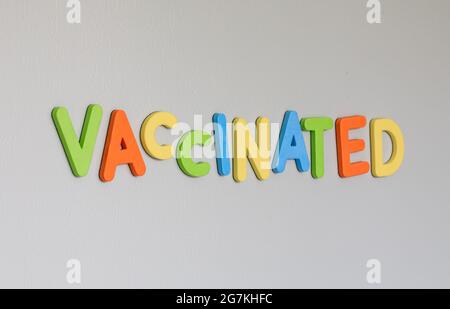 Message on the fridge saying a word in relation to the vaccine with colourful letters Stock Photo