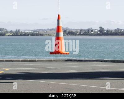 AUCKLAND, NEW ZEALAND - Jun 21, 2021: View of road cone hanging in the air. Auckland, New Zealand - June 21, 2021 Stock Photo