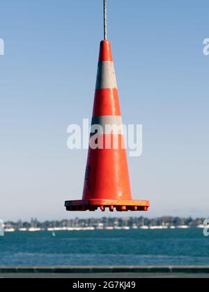 AUCKLAND, NEW ZEALAND - Jun 21, 2021: View of road cone hanging in the air. Auckland, New Zealand - June 21, 2021 Stock Photo