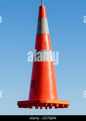 AUCKLAND, NEW ZEALAND - Jun 21, 2021: View of road cone hanging in the air. Auckland, New Zealand - June 21, 2021 Stock Photo