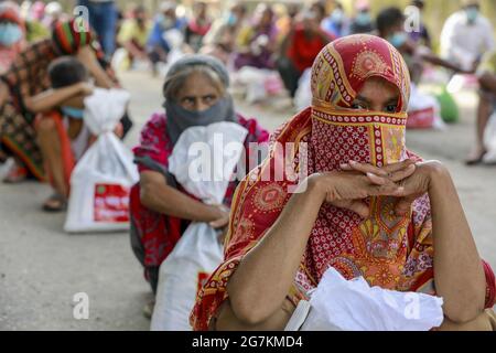 Low income people receive emergency food items provided by Bangladesh Army during the nationwide lockdown to curb the spread of coronavirus (COVID-19) in Dhaka, Bangladesh, July 14, 2021. Photo by Suvra Kanti Das/ABACAPRESS.COM Stock Photo