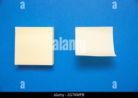 Two white sticky notes with space for text isolated on blue background Stock Photo