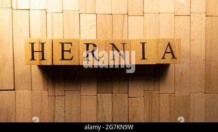 The word Hernia was created from wooden letter cubes. Disease and health. close up. Stock Photo