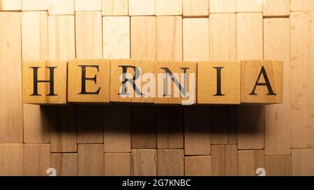 The word Hernia was created from wooden letter cubes. Disease and health. close up. Stock Photo