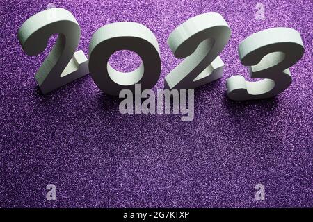 2023 Happy New Year with space copy on purple glitter background Stock Photo