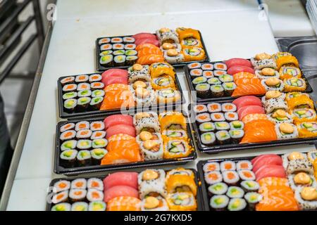 Japanese sushi food. Maki ands rolls with tuna, salmon, shrimp, crab and avocado, assorted sushi at the market in Tarragona Stock Photo