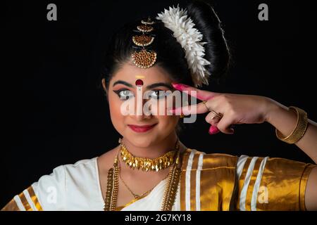 Beautiful Mohiniattam dancer depicting the beauty of eye through her dance form Stock Photo