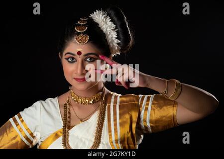 Beautiful Mohiniattam dancer depicting the beauty of eye through her dance form Stock Photo