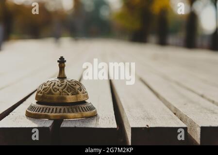 Vintage service bell on wooden surface, horizontal photo Stock Photo