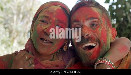 Multiethnic group of happy cheerful people celebrating the festival of Holi, India Stock Photo