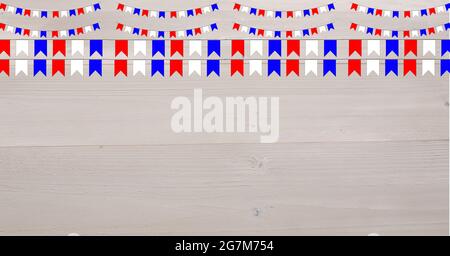 Digitally generated image of red and blue bunting flag decorations against wooden background Stock Photo