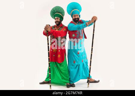 Two Bhangra Dancers standing with Khunda Stock Photo