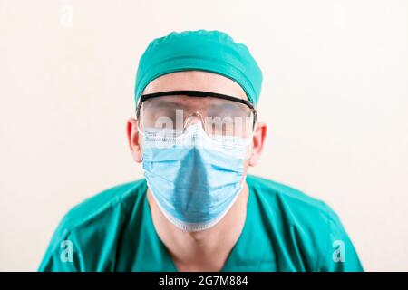 The doctor is wearing a mask and misted goggles. Stock Photo