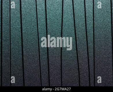 Lined black metal background with chameleon effect. Stock Photo
