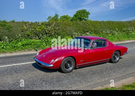 1968 60s red Lotus Elan +2 1588cc petrol coupe; Two seater sports cars: Lotus Type 26 drop head coupé (DHC) marketed as the Elan 1500, Elan 1600, and Elan S2 en-route to Capesthorne Hall classic May car show, Cheshire, UK Stock Photo