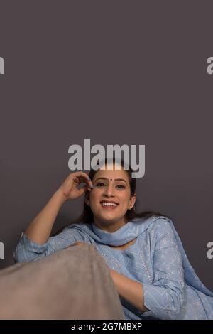 A cheerful woman sitting in her room. Stock Photo