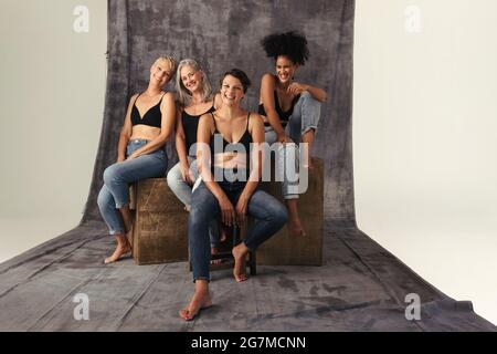 Group of diverse women with natural bodies in lingerie looking at camera  with a smile. Multiracial women looking proud of their bodies Stock Photo -  Alamy