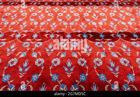 Part of red carpet or rug in muslim mosque.  Prayer mat in the Blue Mosque in Istanbul Stock Photo