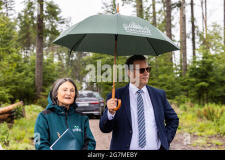 Albbruck, Germany. 15th July, 2021. Freiburg District President Bärbel Schäfer and State Minister Peter Hauk (CDU, with umbrella) stand during an inspection in the forest. The southern Black Forest is one of the regions in Baden-Württemberg most affected by extreme weather-related forest damage. In order to develop solutions, the forest was declared a model area. The aim of the project is to support and quickly help forest owners both in dealing with the damage and in reforesting the damaged areas. Credit: Philipp von Ditfurth/dpa/Alamy Live News Stock Photo