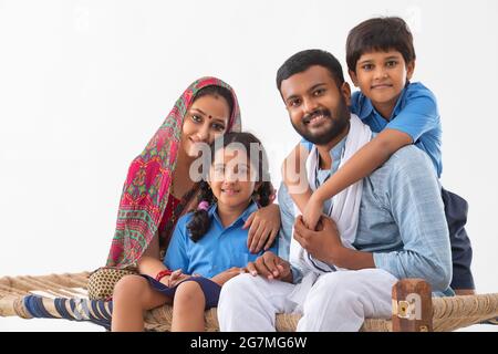 PORTRAIT OF A COMPLETE RURAL FAMILY HAPPILY LOOKING AT CAMERA Stock Photo