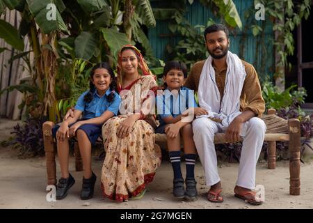 PORTRAIT OF A HAPPY RURAL FAMILY POSING HAPPILY OUTSIDE Stock Photo
