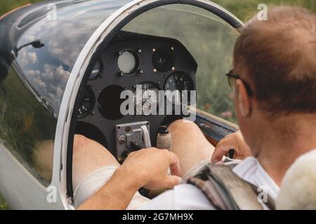 Pilot prepares for flight and checks the aerometric instruments altimeter artificial horizon heading indicator airspeed indicator, variometer. Glider Stock Photo