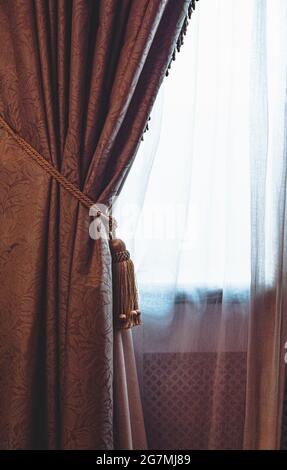 Window covered by a net curtain in an English stately home. Stock Photo