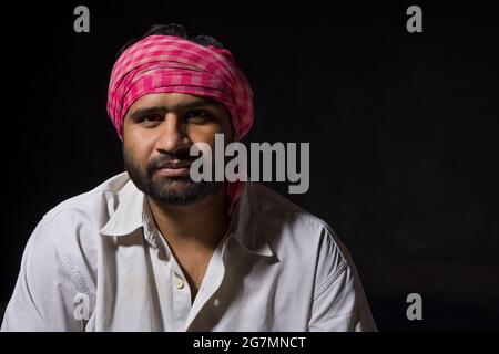 PORTRAIT OF A TURBANED LABOURER LOOKING AT CAMERA Stock Photo