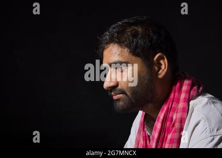 A TIRED LABOURER SITTING AND THINKING Stock Photo