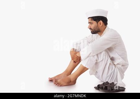 PORTRAIT OF A COMMON MAN SITTING AND THINKING Stock Photo