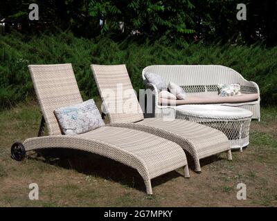 Two outdoor chaise lounge chairs, sofa and table. Garden furniture. Outdoor furniture set Stock Photo
