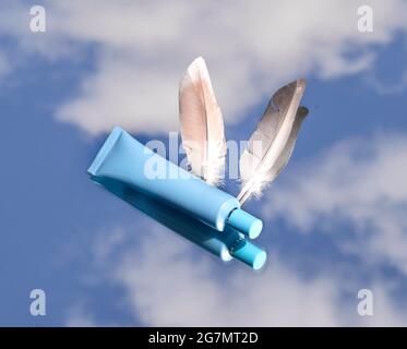 Luxury cosmetic Bottle package skin care cream, Beauty cosmetic product poster, on blue cloudy sky Stock Photo