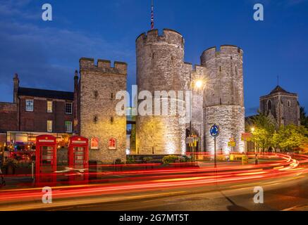 Westgate Towers medieval gateway at night with traffic trails or light trails Canterbury Kent England UK GB Europe Stock Photo