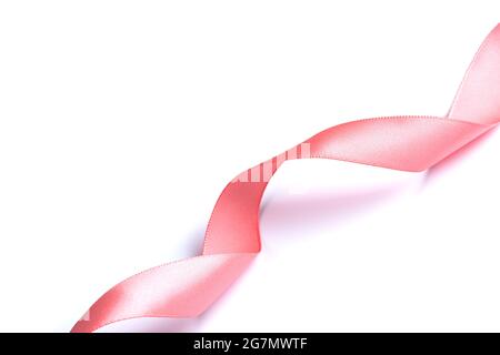 Pink silk ribbon curled on white Stock Photo