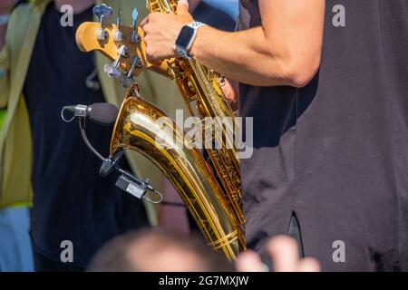 Crop man playing saxophone on street Stock Photo