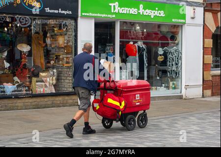 Windsor, Berkshire, UK. 14th July, 2021. A postman on his round in Windsor. Credit: Maureen McLean/Alamy Stock Photo