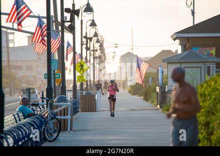 North Wildwood, United States. 15th July, 2021. Jill Snowdon of Dallas, Pa., runs along the promenade on a warm summer day Thursday, July 15, 2021 at in North Wildwood, New Jersey. Jill is training to participate in the New York City Marathon as a charity runner. Temperatures are expected in the 90's through the rest of this week. Credit: William Thomas Cain/Alamy Live News Stock Photo
