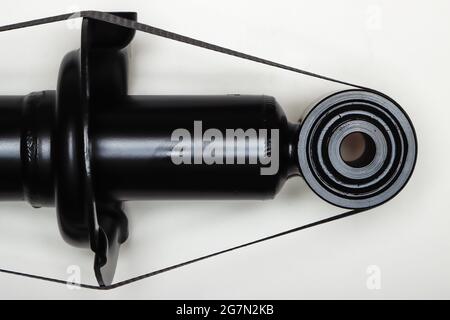 The shock absorber mount for the machine lies on a flat surface. Spare parts for the repair of the undercarriage of the vehicle. Details on white background, copy space available. UHD 4K. Stock Photo