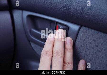 Man's hand at the modern car's inner handle Stock Photo